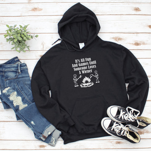 Our Camping hoodie features two adorable stick figure people roasting wieners over a cozy campfire. And with the hilarious slogan "It's All Fun & Games Until Someone Loses A Wiener," you'll be the life of the party at any camping trip!